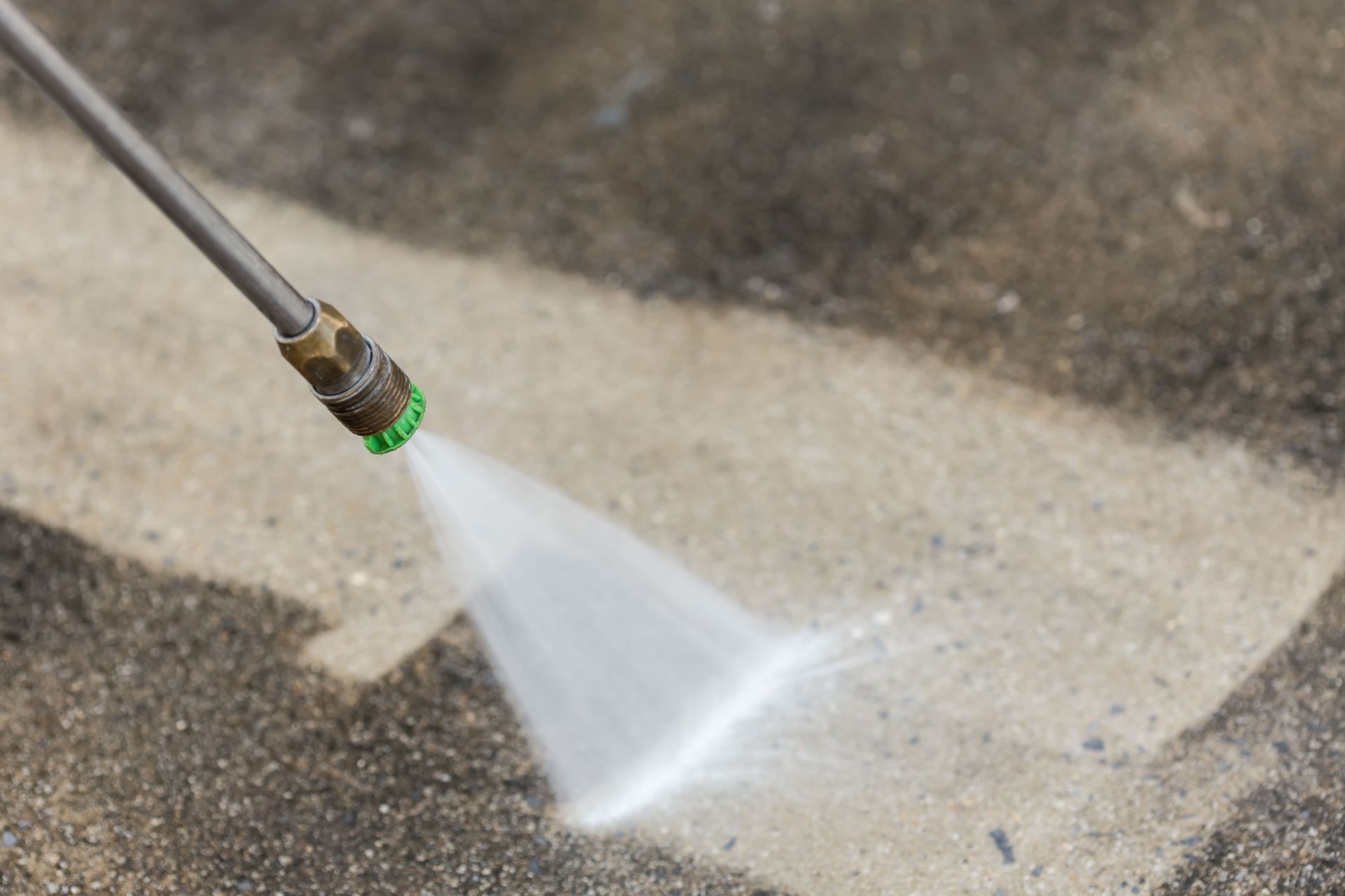 Power washer cleaning sidewalk in Smyrna commercial area